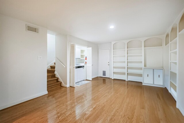 2322 Steel St Unit 19, Houston, TX 77098 - empty room with light wood-type flooring, stairs, and baseboards