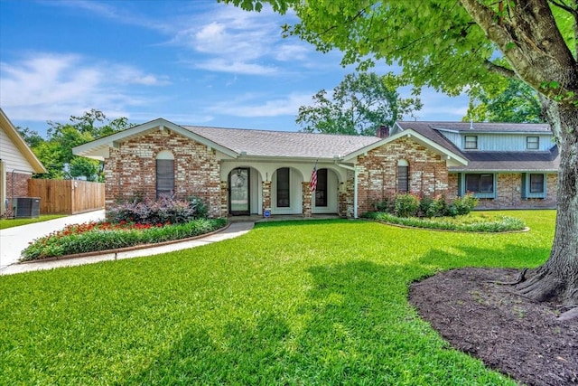 2216 S Rayburn Ct, Pasadena, TX 77502 - view of front of house featuring central air condition unit, brick siding, covered porch, and a chimney