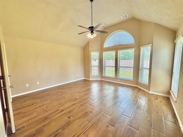 2115 Mooncrest Dr, Houston, TX 77089 - empty room featuring wood tiled floors, a textured ceiling, vaulted ceiling, healthy amount of natural light, and ceiling fan