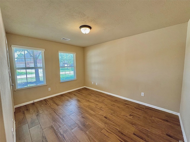2115 Mooncrest Dr, Houston, TX 77089 - spare room with wood finished floors, baseboards, and a textured ceiling