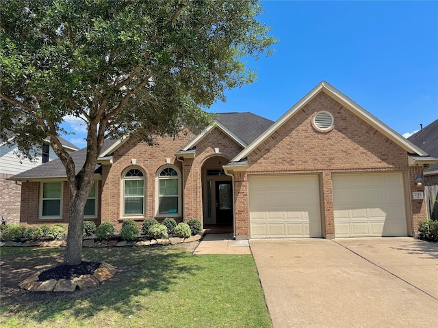2115 Mooncrest Dr, Houston, TX 77089 - traditional-style house with an attached garage, concrete driveway, brick siding, and a front lawn