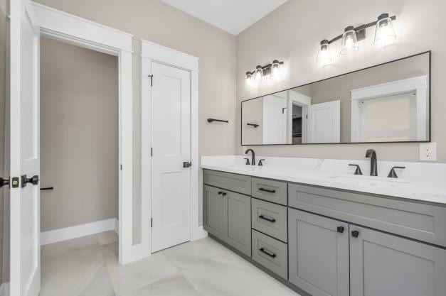 1708 Capron St Unit A, Houston, TX 77020 - bathroom with double vanity, baseboards, and marble look tiles