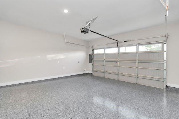 1708 Capron St Unit A, Houston, TX 77020 - garage with electric panel, baseboards, and a garage door opener