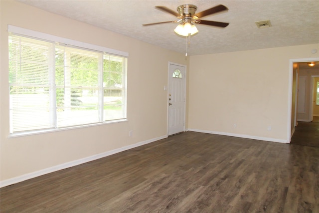 916 Cedar Bayou Rd, Baytown, TX 77520 - empty room featuring dark wood-type flooring, ceiling fan, baseboards, and a textured ceiling