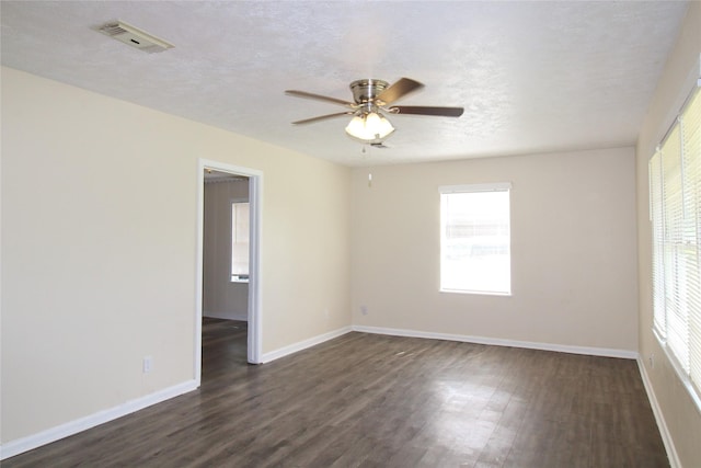 916 Cedar Bayou Rd, Baytown, TX 77520 - empty room with dark wood finished floors, healthy amount of natural light, and baseboards