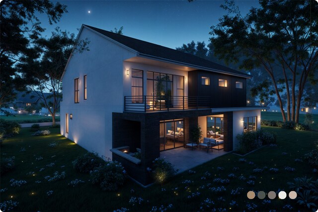 1407 Indiana St, Houston, TX 77006 - back of house at night featuring a patio, a lawn, a balcony, and stucco siding