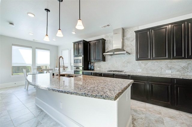 1103 River Delta Ln, Rosenberg, TX 77469 - kitchen with wall chimney exhaust hood, a sink, stainless steel appliances, backsplash, and light stone countertops