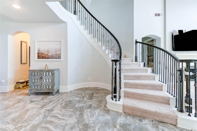 1103 River Delta Ln, Rosenberg, TX 77469 - staircase featuring arched walkways, marble tiled flooring, and baseboards