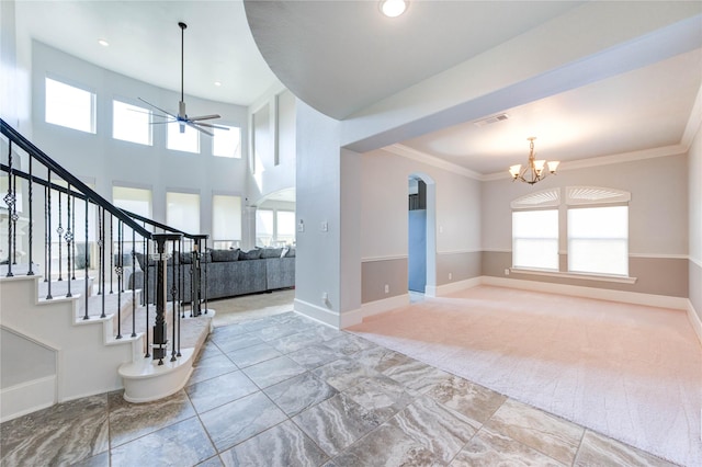 1103 River Delta Ln, Rosenberg, TX 77469 - foyer entrance with a chandelier, ceiling fan, arched walkways, baseboards, and stairs