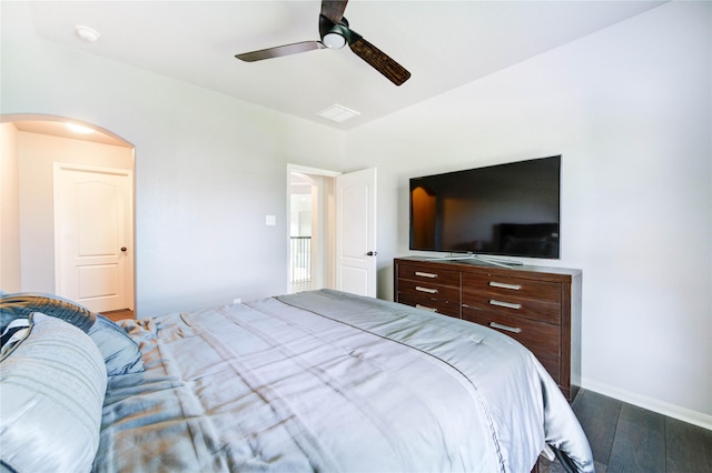 1103 River Delta Ln, Rosenberg, TX 77469 - bedroom with dark wood-type flooring, arched walkways, ceiling fan, and baseboards