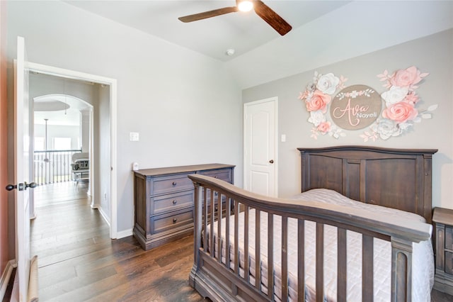 1103 River Delta Ln, Rosenberg, TX 77469 - bedroom with dark wood finished floors, baseboards, a ceiling fan, vaulted ceiling, and arched walkways