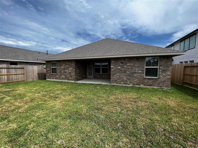 13620 Sorico Bay Dr, Texas City, TX 77568 - back of house featuring brick siding, a patio area, and roof with shingles