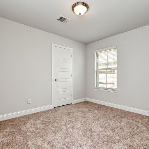 13620 Sorico Bay Dr, Texas City, TX 77568 - carpeted spare room featuring baseboards