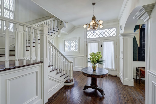 200 Westmoreland St, Houston, TX 77006 - entryway with a decorative wall, stairs, a chandelier, dark wood finished floors, and crown molding