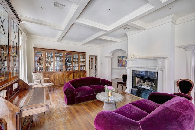 200 Westmoreland St, Houston, TX 77006 - living area with wood finished floors, beam ceiling, arched walkways, a high end fireplace, and crown molding