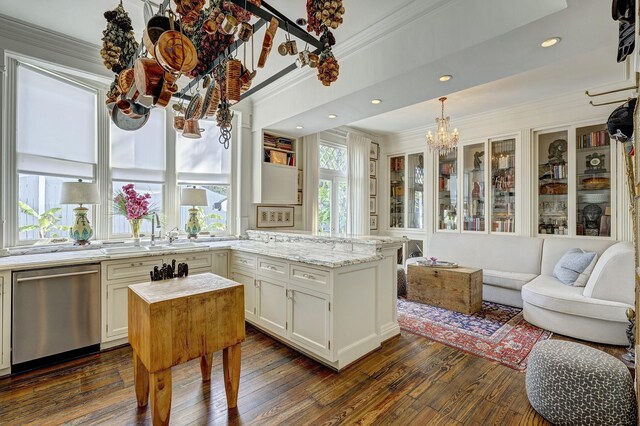 200 Westmoreland St, Houston, TX 77006 - kitchen featuring stainless steel dishwasher, a sink, crown molding, a peninsula, and dark wood finished floors