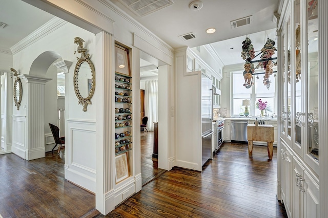 200 Westmoreland St, Houston, TX 77006 - corridor with crown molding, dark wood finished floors, a desk, arched walkways, and recessed lighting