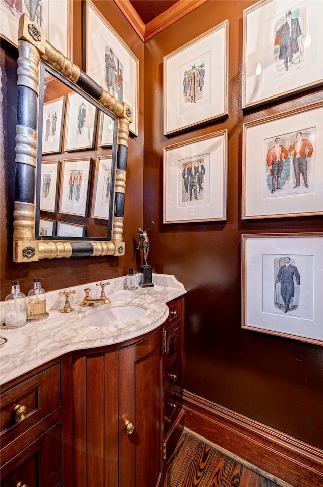200 Westmoreland St, Houston, TX 77006 - bathroom featuring crown molding, vanity, and wood finished floors