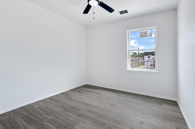 7939 Goode St, Houston, TX 77012 - unfurnished room featuring wood finished floors, ceiling fan, and baseboards