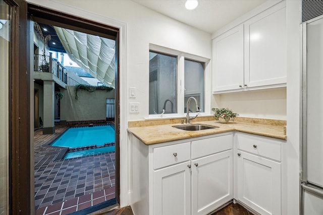 3224 Alabama Ct, Houston, TX 77027 - kitchen featuring a sink, white cabinetry, and light countertops