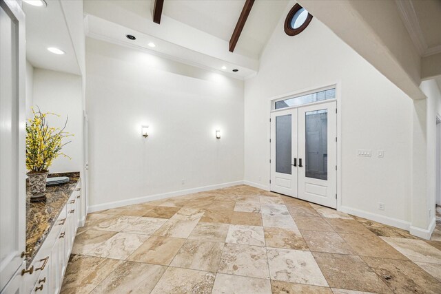3224 Alabama Ct, Houston, TX 77027 - spare room with beam ceiling, light stone finish floors, high vaulted ceiling, baseboards, and recessed lighting