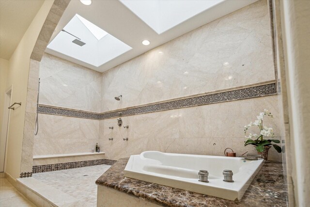 3224 Alabama Ct, Houston, TX 77027 - bathroom with a bath, a skylight, tile walls, recessed lighting, and a tile shower