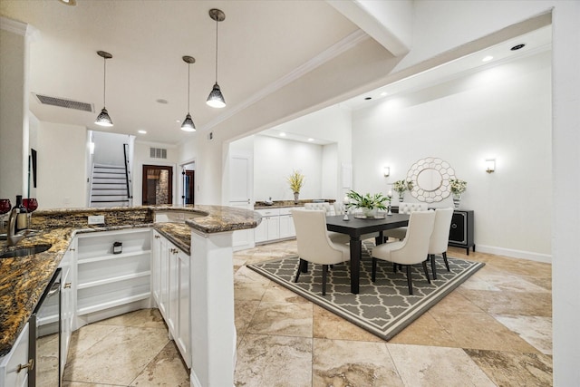 3224 Alabama Ct, Houston, TX 77027 - kitchen with ornamental molding, white cabinetry, dark stone counters, recessed lighting, and a peninsula