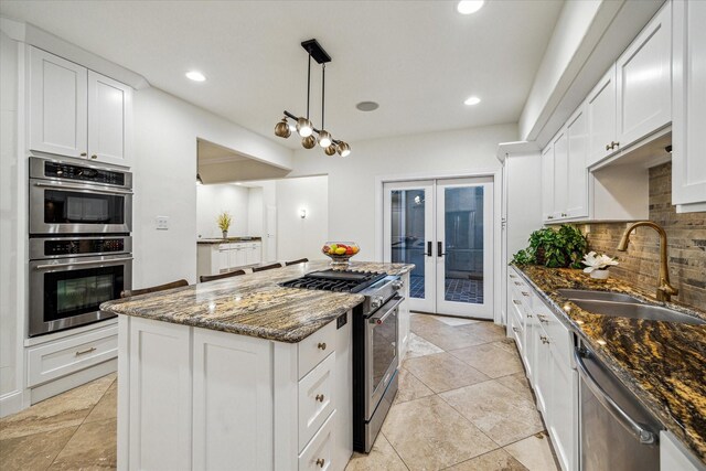 3224 Alabama Ct, Houston, TX 77027 - kitchen with stainless steel appliances, a sink, french doors, backsplash, and dark stone countertops