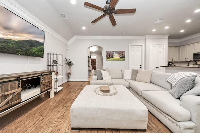 2223 Hilshire Trail Dr, Houston, TX 77080 - living area featuring arched walkways, a ceiling fan, ornamental molding, recessed lighting, and light wood-type flooring