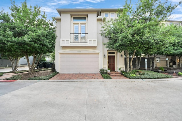 2223 Hilshire Trail Dr, Houston, TX 77080 - view of front facade featuring a balcony, stucco siding, an attached garage, and driveway