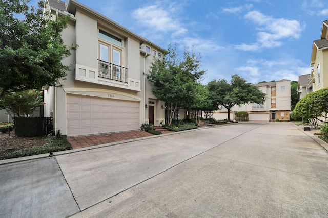 2223 Hilshire Trail Dr, Houston, TX 77080 - view of front of home featuring stucco siding, a balcony, and an attached garage
