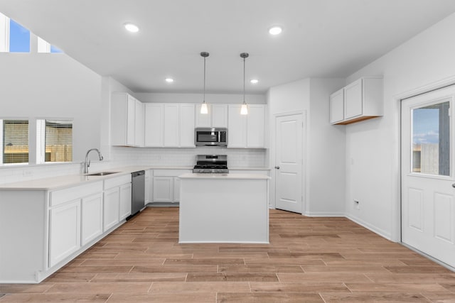 9022 Gull Cyn, Downs, Baytown, TX 77521 - kitchen with appliances with stainless steel finishes, a sink, decorative backsplash, healthy amount of natural light, and recessed lighting