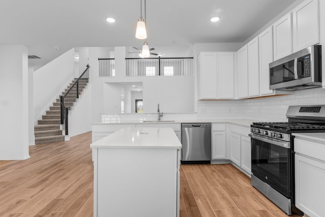 9022 Gull Cyn, Downs, Baytown, TX 77521 - kitchen featuring appliances with stainless steel finishes, a sink, light countertops, light wood-style flooring, and recessed lighting