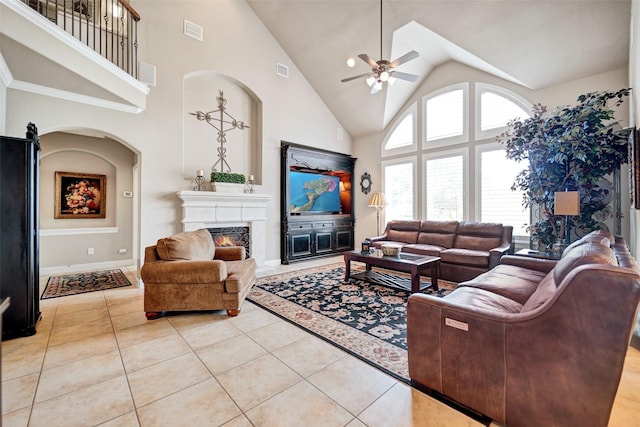 25606 Payton Chase Ct, Katy, TX 77494 - living area featuring a ceiling fan, high vaulted ceiling, a lit fireplace, light tile patterned floors, and baseboards