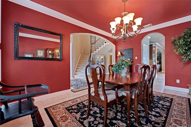 25606 Payton Chase Ct, Katy, TX 77494 - tiled dining room with arched walkways, a chandelier, stairs, baseboards, and crown molding