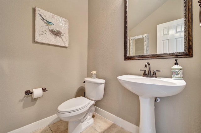 25606 Payton Chase Ct, Katy, TX 77494 - half bathroom featuring toilet, vaulted ceiling, tile patterned floors, and baseboards