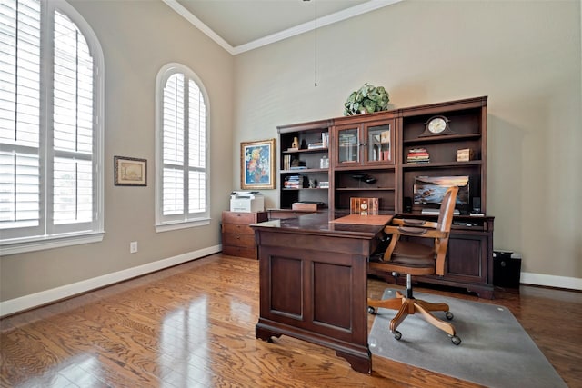 25606 Payton Chase Ct, Katy, TX 77494 - home office featuring crown molding, baseboards, a towering ceiling, and wood finished floors