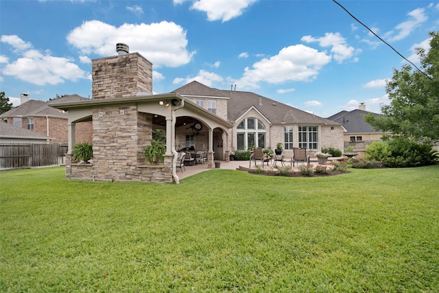 25606 Payton Chase Ct, Katy, TX 77494 - rear view of property with a patio, a chimney, and stone siding