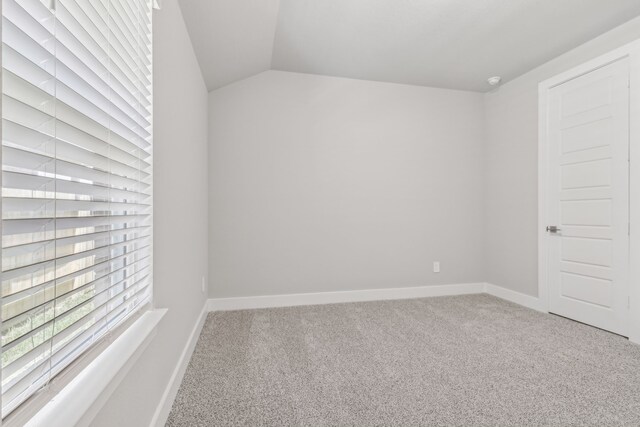 2010 Bluff Oak Ct, Conroe, TX 77304 - carpeted empty room featuring baseboards and lofted ceiling