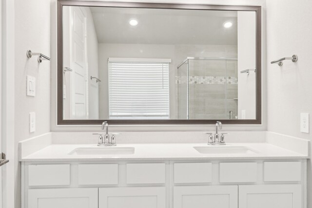 2010 Bluff Oak Ct, Conroe, TX 77304 - bathroom featuring double vanity, a stall shower, and recessed lighting