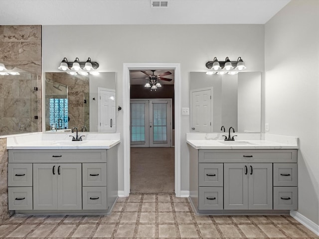 15615 Atwood Ln, Crosby, TX 77532 - full bath with a tile shower, two vanities, baseboards, and a ceiling fan