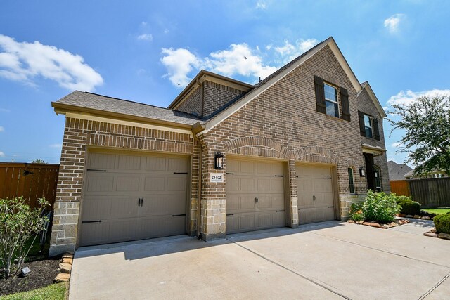 23402 Skylark Falls Trl, Katy, TX 77493 - view of front of home featuring brick siding, driveway, and a garage