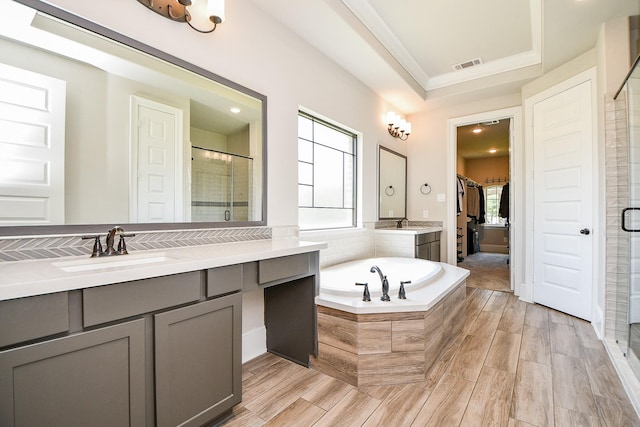 23402 Skylark Falls Trl, Katy, TX 77493 - bathroom with a stall shower, vanity, a garden tub, a spacious closet, and ornamental molding