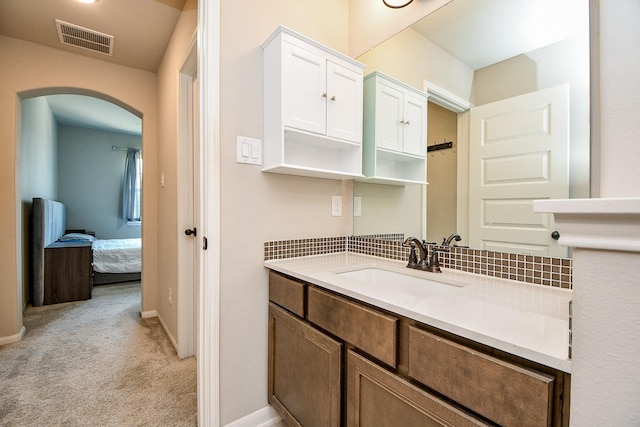 23402 Skylark Falls Trl, Katy, TX 77493 - ensuite bathroom featuring vanity, tasteful backsplash, and baseboards