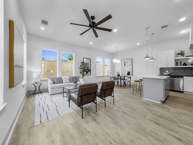 2410 Vaughn St Unit B, Houston, TX 77093 - living room featuring light wood-style flooring, a ceiling fan, baseboards, recessed lighting, and a chandelier