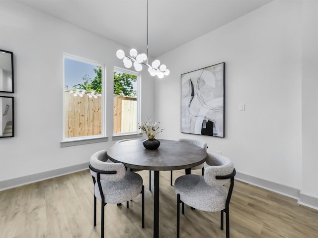 2410 Vaughn St Unit B, Houston, TX 77093 - dining room featuring wood finished floors, a chandelier, and baseboards