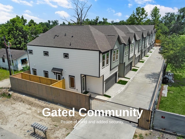 2410 Vaughn St Unit B, Houston, TX 77093 - rear view of property with a shingled roof and a garage