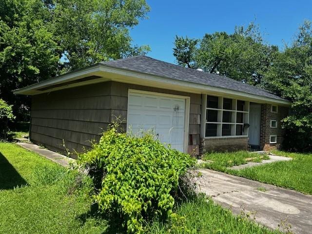 4030 Bayou Rd, Beaumont, TX 77707 - view of home's exterior featuring a garage, brick siding, concrete driveway, and a lawn