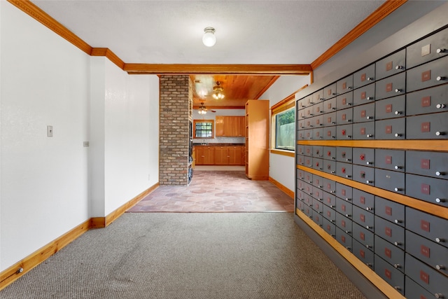914 S Hill St, Alvin, TX 77511 - unfurnished living room featuring ornamental molding, light carpet, baseboards, and mail area
