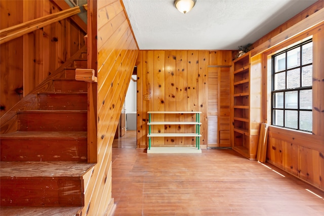 914 S Hill St, Alvin, TX 77511 - stairway featuring wood walls and wood finished floors